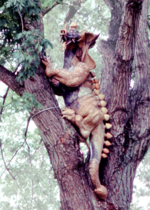 Monumental 7’8” stoneware dragon sculpture commissioned by John Gardner in 1972, anchored in a silver maple tree with reinforced concrete, lag bolts, and stainless steel cable.