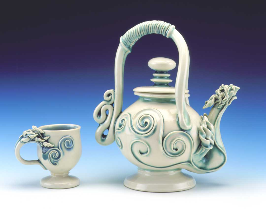 Porcelain dragon teapot with celadon glaze, wheel‑thrown and hand‑sculpted by artist craftsman.