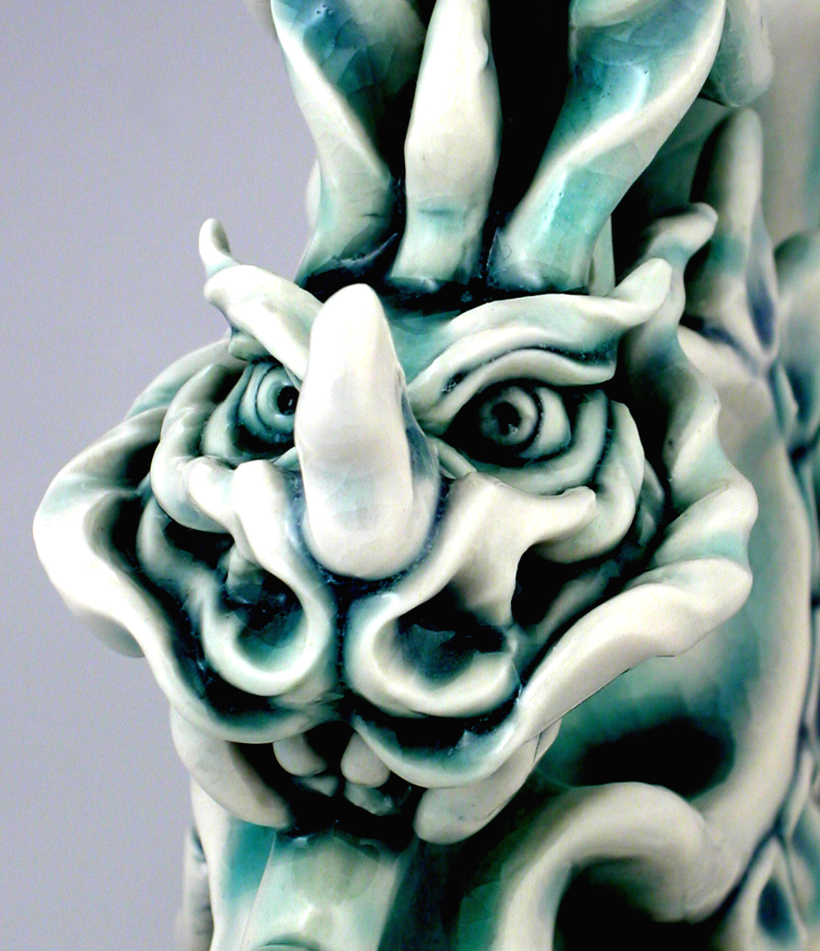 Porcelain Tatsu dragon sculpture, frontal face detail.